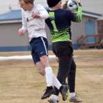 Nikiski goalie Kevin Love snatches the ball before Homers Kaiden Bogie can head it Saturday, May 4, 2024, at Nikiski Middle-High School in Nikiski, Alaska. (Photo by Jeff Helminiak/Peninsula Clarion)