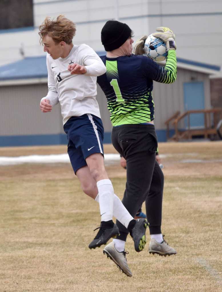 Nikiski goalie Kevin Love snatches the ball before Homers Kaiden Bogie can head it Saturday, May 4, 2024, at Nikiski Middle-High School in Nikiski, Alaska. (Photo by Jeff Helminiak/Peninsula Clarion)