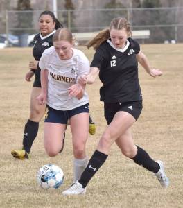 Homers Talia Weisser dribbles against Nikiskis Zoey Ellis on Saturday, May 4, 2024, at Nikiski Middle-High School in Nikiski, Alaska. (Photo by Jeff Helminiak/Peninsula Clarion)