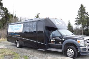One of the Alaska Bus Company's luxury shuttle buses is photographed on Friday, May 10, 2024 next to the parking lot of the Aspen Hotel in Homer, Alaska. (Delcenia Cosman/Homer News)