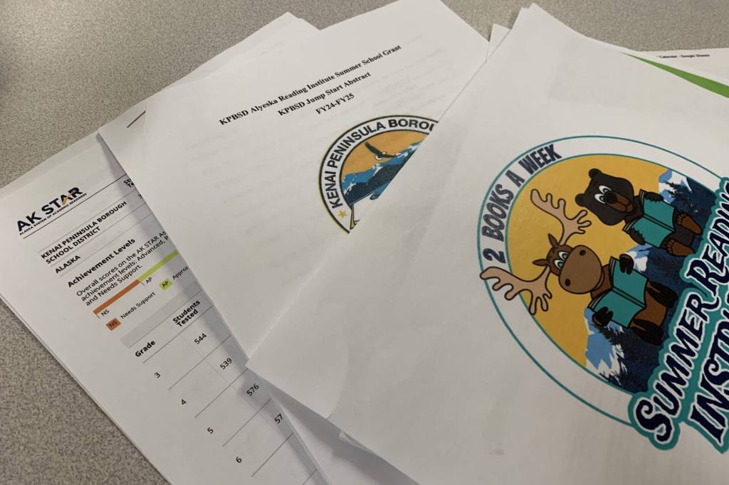 Ashlyn OHara/Peninsula Clarion
The Kenai Peninsula Borough School Districts grant application for funds to support summer reading programs, along with other reading intervention documents, are splayed on a desk in the Peninsula Clarion offices on Monday, May 13, 2024 in Kenai, Alaska.