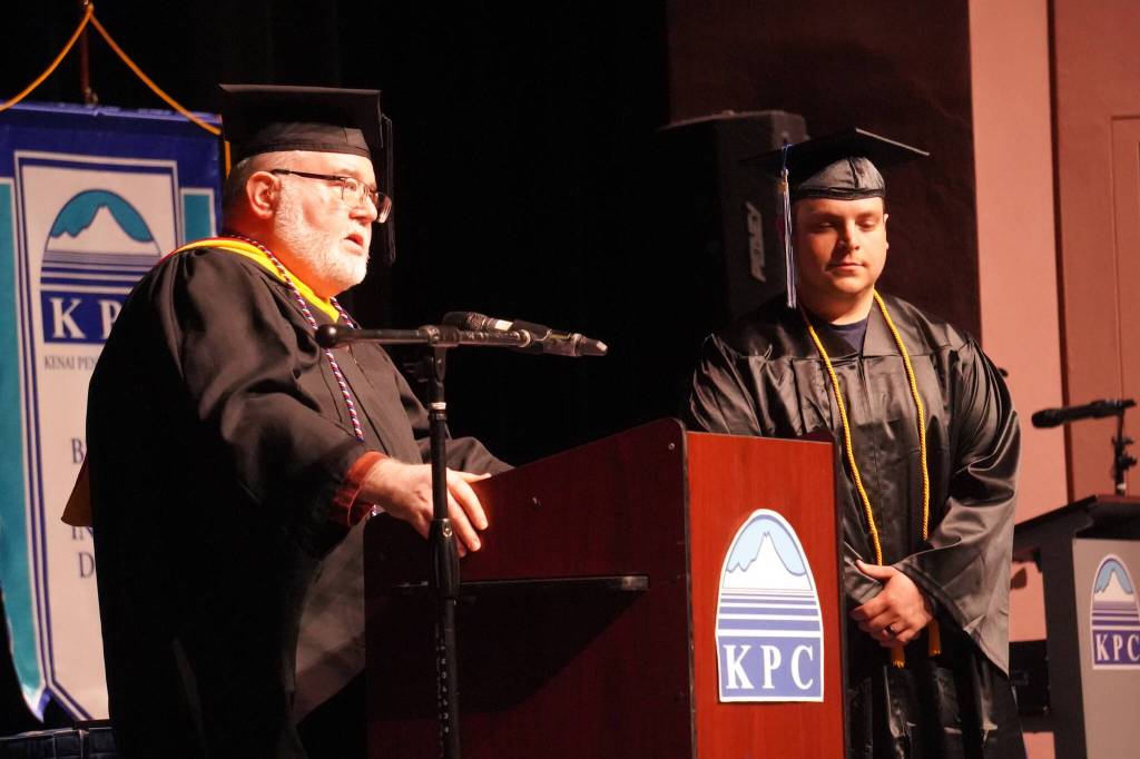 Faculty Chair Bill Howell names David Wolf a recipient of a Faculty Choice Award during the 54th Annual Kenai Peninsula College Commencement Ceremony at Kenai Central High School in Kenai, Alaska, on Thursday, May 9, 2024. (Jake Dye/Peninsula Clarion)
