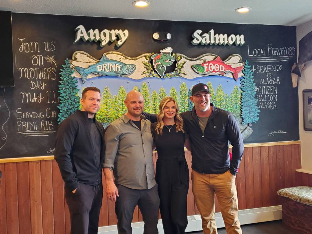 Angry Salmon owners and manager Cameron Johnson, Josh Broda, Chelsea Anderson and Rob Yundt pose in the front of the restaurant during the grand opening ceremony on Saturday, May 11, 2024 in Anchor Point, Alaska. (Delcenia Cosman/Homer News)
