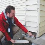Soldotna Elementary School Principal Dr. Austin Stevenson points out corroded insulation outside of the school building on Friday, Sept. 30, 2022 in Soldotna . (Ashlyn OHara/Peninsula Clarion)