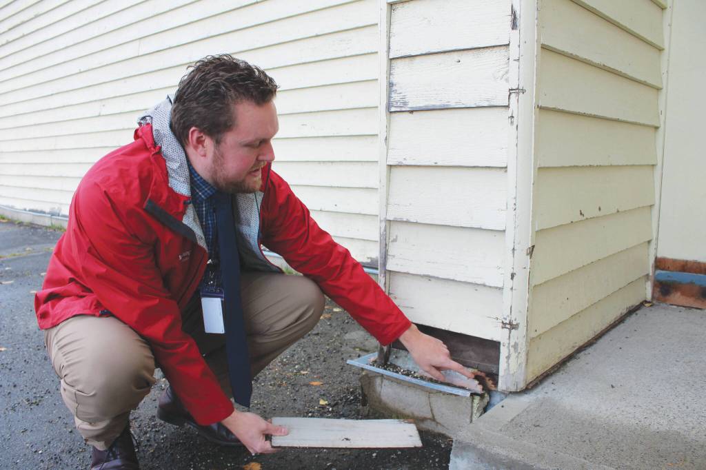 Soldotna Elementary School Principal Dr. Austin Stevenson points out corroded insulation outside of the school building on Friday, Sept. 30, 2022 in Soldotna, Alaska. (Ashlyn OHara/Peninsula Clarion)