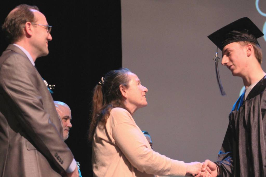 Kenai Peninsula Director of Information Services Eric Soderquist (left) and school board member Diane MacRae (center) congratulate graduates during Connections Homeschools commencement ceremony on Thursday, May 16, 2024 in Soldotna, Alaska. (Ashlyn OHara/Peninsula Clarion)