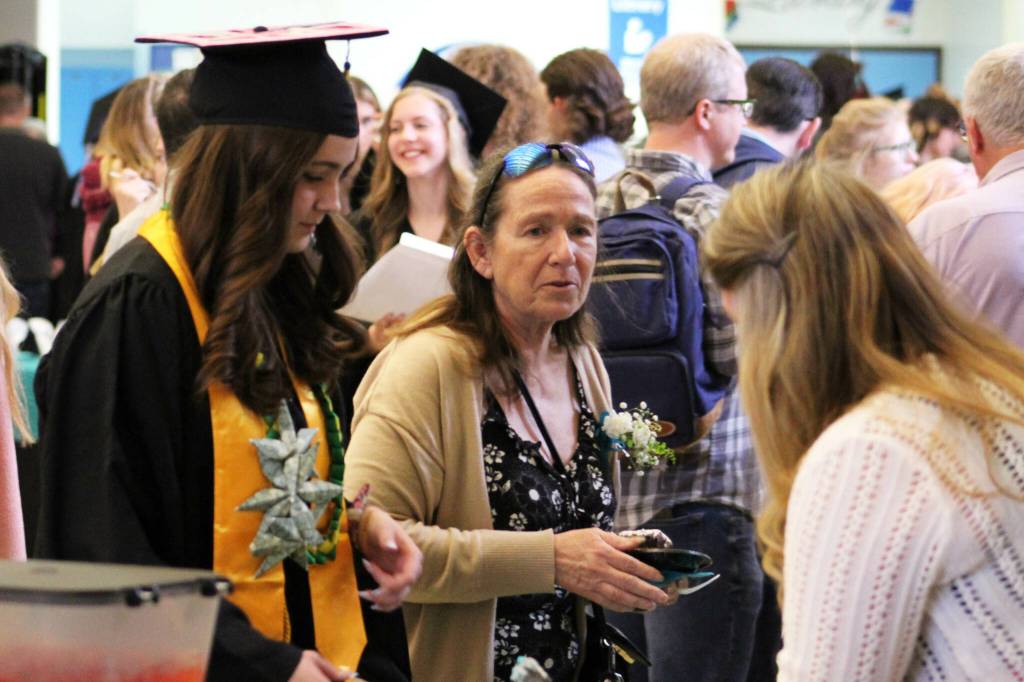 Kenai Peninsula Borough School District school board member Dianne MacRae (center) joins graduates for cake after Connections Homeschools 2024 commencement ceremony on Thursday, May 16, 2024 in Soldotna, Alaska. (Ashlyn OHara/Peninsula Clarion)