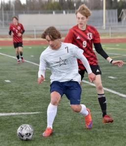 Soldotnas Johnny Wardas shields the ball from Kenai Centrals Zane James on Saturday, May 19, 2024, at the Peninsula Conference tournament at Kenai Central High School in Kenai, Alaska. (Photo by Jeff Helminiak/Peninsula Clarion)