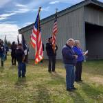 Paula Gallagher (right rear), American Legion Post 16 Auxiliary Chaplain, stands with Post Commander Craig Teigen (right front) as she recites a prayer at the start of the Memorial Day service held at Hickerson Memorial Cemetery on Monday, May 27, 2024 in Homer, Alaska. (Delcenia Cosman/Homer News)