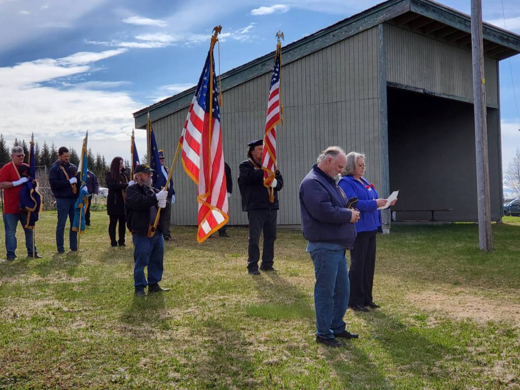 Paula Gallagher (right rear), American Legion Post 16 Auxiliary Chaplain, stands with Post Commander Craig Teigen (right front) as she recites a prayer at the start of the Memorial Day service held at Hickerson Memorial Cemetery on Monday, May 27, 2024 in Homer, Alaska. (Delcenia Cosman/Homer News)