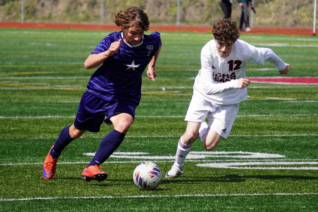 Soldotnas Johnathan Wardas and Juneau-Douglas Ryan Thibodeau battle for the ball during the ASAA Division II Soccer State Championships at Veterans Memorial Field in Wasilla, Alaska, on Saturday, May 25, 2024. (Jake Dye/Peninsula Clarion)