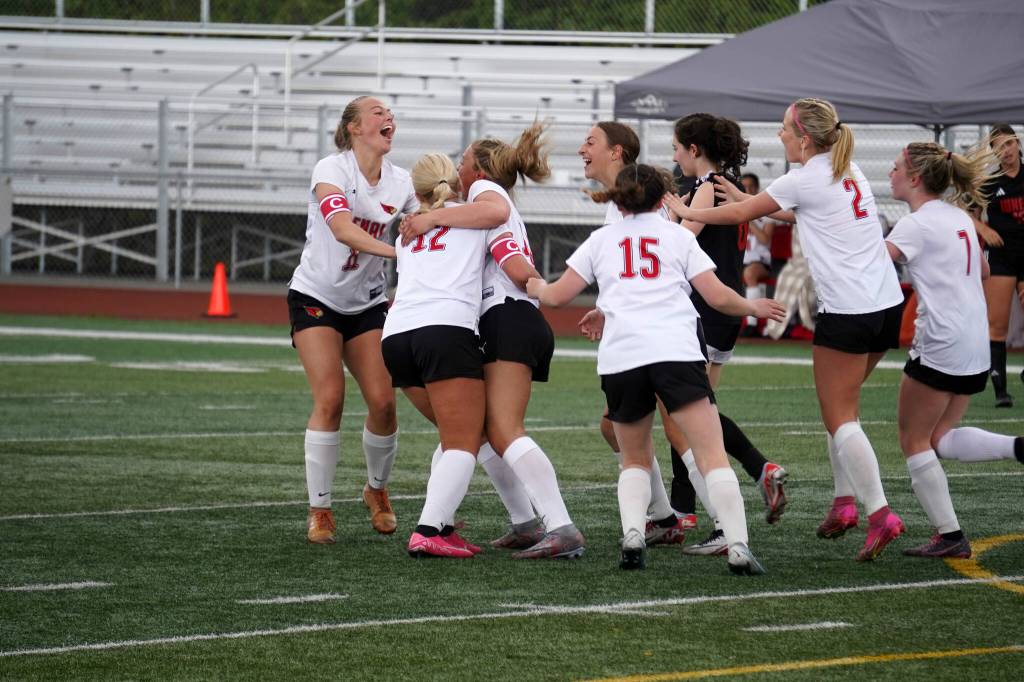 The Kenai Central High School girls celebrate after a goal by Katie Johnson during the ASAA Soccer Division II State Championships at Veterans Memorial Field in Wasilla, Alaska, on Saturday, May 25, 2024. (Jake Dye/Peninsula Clarion)