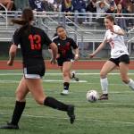 Kenais Sarah Baisden controls the ball against defense from Juneau-Douglas Kenzie Simonson and Milina Mazon during the ASAA Soccer Division II State Championships at Veterans Memorial Field in Wasilla, Alaska, on Saturday, May 25, 2024. (Jake Dye/Peninsula Clarion)