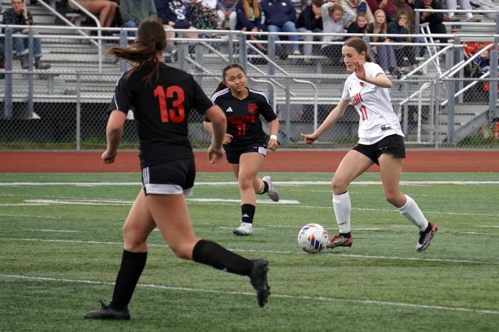 Kenais Sarah Baisden controls the ball against defense from Juneau-Douglas Kenzie Simonson and Milina Mazon during the ASAA Soccer Division II State Championships at Veterans Memorial Field in Wasilla, Alaska, on Saturday, May 25, 2024. (Jake Dye/Peninsula Clarion)