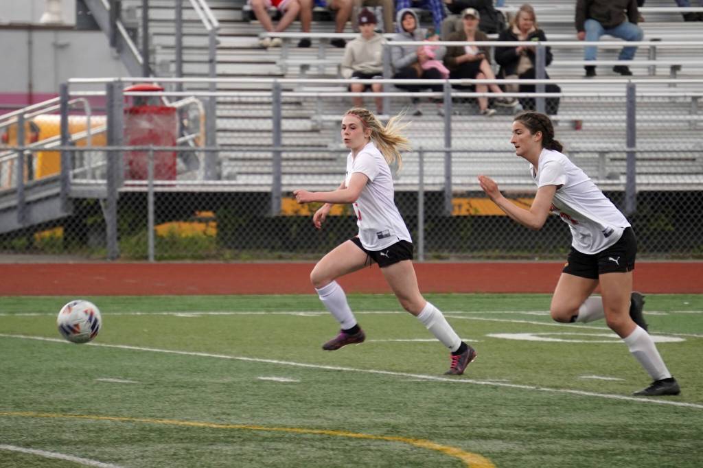 Kenais Tait Cooper and Chloe Grimm race to control the ball during the ASAA Soccer Division II State Championships at Veterans Memorial Field in Wasilla, Alaska, on Saturday, May 25, 2024. (Jake Dye/Peninsula Clarion)