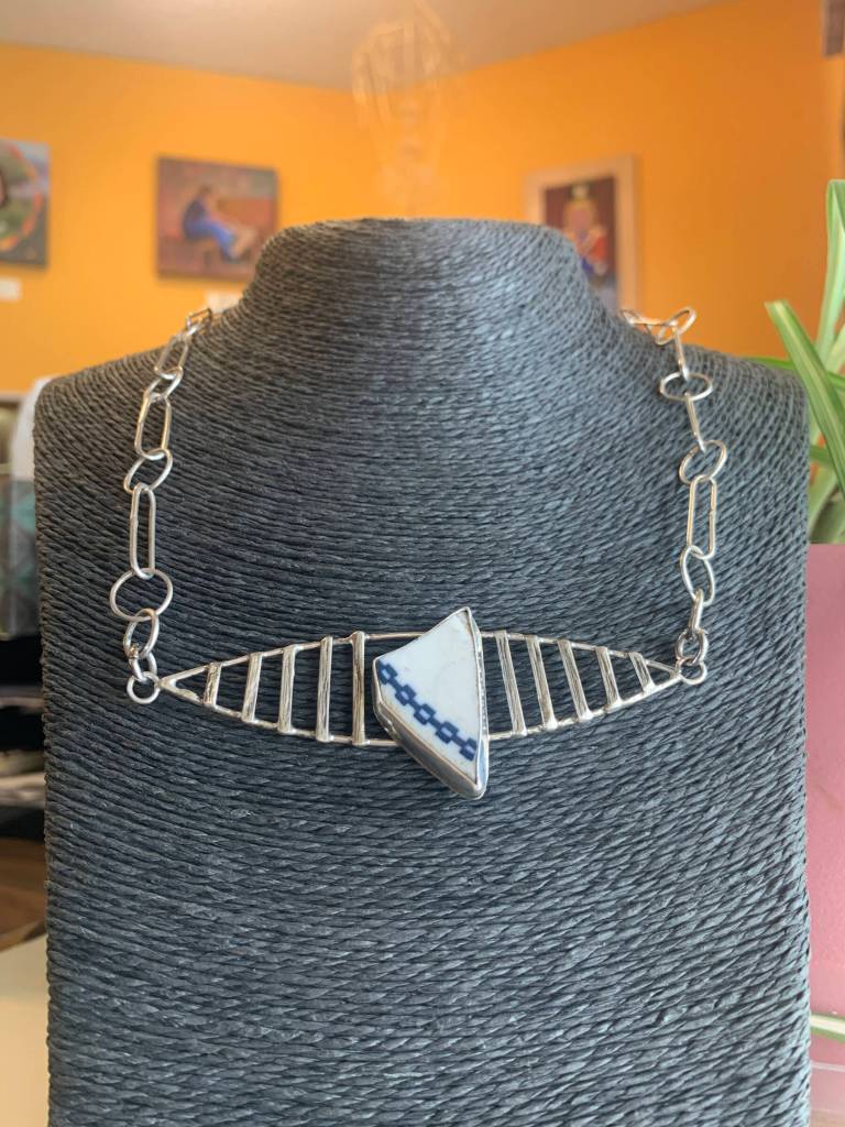This B&O Railroad China Necklace by Carley Conemac is one of dozens of metal pieces on display at Homer Council on the Arts through June. Photo provided by Homer Council on the Arts