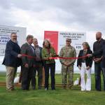 Jake Dye/Peninsula Clarion
City of Kenai Public Works Director Scott Curtain; City of Kenai Mayor Brian Gabriel; Kenai Peninsula Borough Mayor Peter Micciche; Sen. Lisa Murkowski; Col. Jeffrey Palazzini; Elaina Spraker; Adam Trombley; and Kenai City Manager Terry Eubank cut the ribbon to celebrate the start of work on the Kenai River Bluff Stabilization Project on the bluff above the Kenai River in Kenai on Monday.