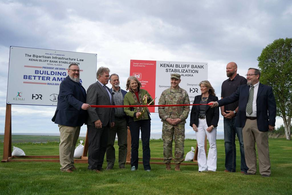 City of Kenai Public Works Director Scott Curtain, City of Kenai Mayor Brian Gabriel, Kenai Peninsula Borough Mayor Peter Micciche, Sen. Lisa Murkowski, Col. Jeffrey Palazzini, Elaina Spraker, Adam Trombley and Kenai City Manager Terry Eubank cut the ribbon to celebrate the start of work on the Kenai River Bluff Stabilization Project on the bluff above the Kenai River in Kenai, Alaska, on Monday, June 10, 2024. (Jake Dye/Peninsula Clarion)