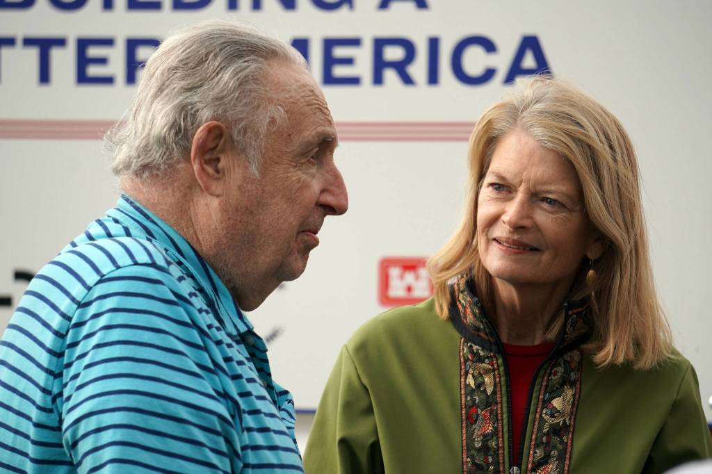 Former Mayor of Kenai John Williams and Sen. Lisa Murkowski chat with one another at the ribbon cutting for the Kenai River Bluff Stabilization Project on the bluff above the Kenai River in Kenai, Alaska, on Monday, June 10, 2024. (Jake Dye/Peninsula Clarion)