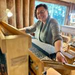 Fiber artist Lisa Talbott weaves a blanket at her Tools of the Trade jack loom on Tuesday, June 11, 2024, in the Kindred Spirits Weaving Studio she shares with Bonita Banks in Homer, Alaska. Photo by Christina Whiting