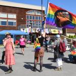 An attendee of the Homer Pride Liberation Celebration on Saturday, June 15, 2024, holds up a BLM Pride flag in the Kachemak Bay Campus parking lot in Homer, Alaska. (Delcenia Cosman/Homer News)
