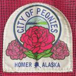 Homers official peony patch is attached to a Nomar tote bag, available for purchase at the Homer Chamber of Commerce, during the month of July. (Photo by Emilie Springer/Homer News)