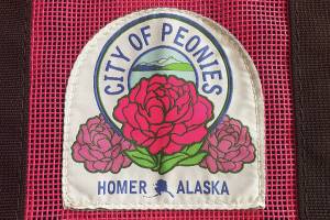 Homers official peony patch is attached to a Nomar tote bag, available for purchase at the Homer Chamber of Commerce, during the month of July. (Photo by Emilie Springer/Homer News)