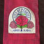 Homers official peony patch is attached to a Nomar tote bag, available for purchase at the Homer Chamber of Commerce, during the month of July. (Photo by Emilie Springer/Homer News)