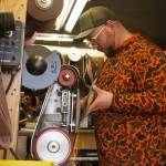 Sparks glitter away as Grey Wilson, of Wilsons Proper Edge, sharpens an ax at Soldotna Creek Park in Soldotna, Alaska, on Wednesday, June 19, 2024. (Jake Dye/Peninsula Clarion)