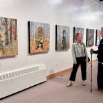 Visitors to the Pratt Museum on Friday, June 7, 2024, take in Inner Stellar, paintings by Marjorie Scholl on display through September. Photo by Christina Whiting