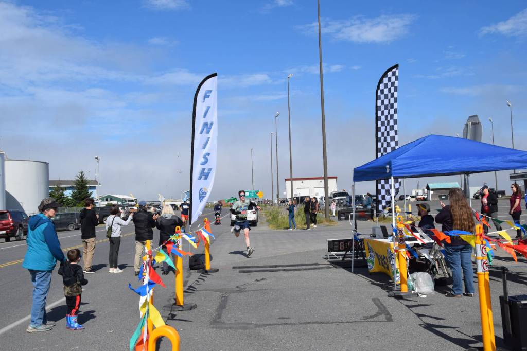 Homers Landon Tinsley dashes across the finish line at Lands End Resort during the Homer Spit Run 10K to the Bay on Saturday, June 29, 2024, in Homer, Alaska. Tinsley came in fourth for the mens group, and was sixth overall in the 10K. (Delcenia Cosman/Homer News)