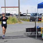 Ben London, from Seattle, Washington, crosses the finish line at Lands End Resort, completing the Homer Spit Run Cosmic Hamlet Half Marathon on Saturday, June 29, 2024, in Homer, Alaska.