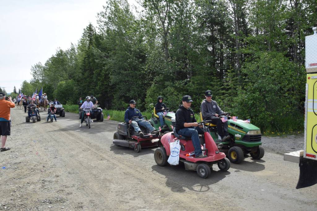 Community members drive an assortment of vehicles in the Anchor Point Fourth of July parade on Thursday, July 4, 2024, in Anchor Point, Alaska. (Delcenia Cosman/Homer News)