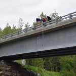 VFW Post 10221 commander Chuck Collins empties a tub of pink ducks over the Anchor River Bridge during the third annual Anchor River Duck Races on Saturday, July 6, 2024, in Anchor Point, Alaska. (Delcenia Cosman/Homer News)