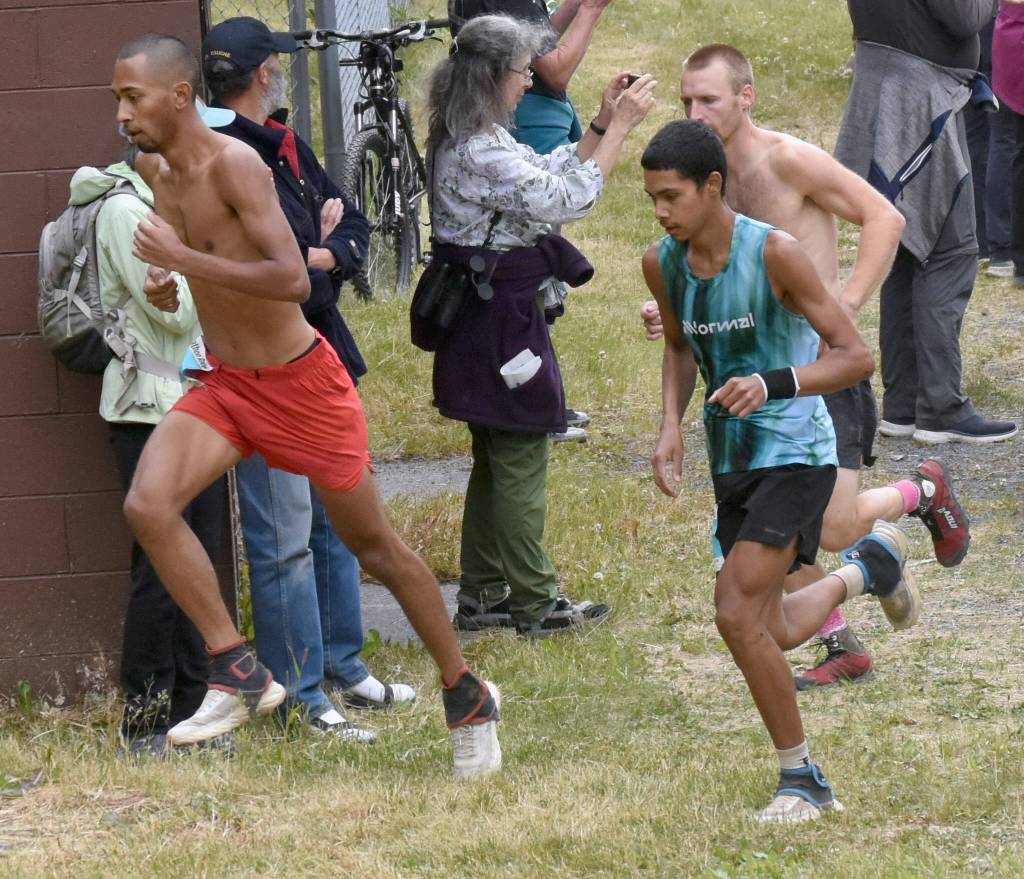 Bodhi Gross and Ali Papillon, both of Manitou Springs, Colorado, approach the mountain in the mens race at the Mount Marathon Race on Thursday, July 4, 2024, in Seward, Alaska. (Photo by Jeff Helminiak/Peninsula Clarion)