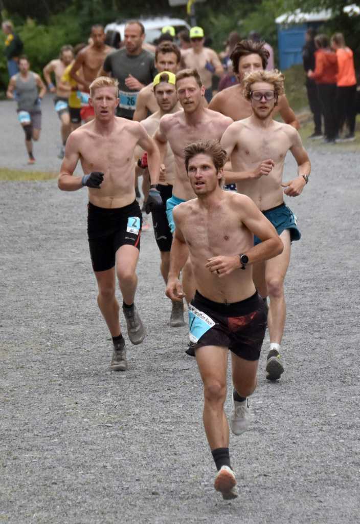 David Norris of Steamboat Springs, Colorado, leads a group of runners to the mountain on the way to victory and setting a new record in the mens race at the Mount Marathon Race on Thursday, July 4, 2024, in Seward, Alaska. (Photo by Jeff Helminiak/Peninsula Clarion)