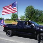 Jake Dye/Peninsula Clarion
A parade of cars and trucks flying flags in support of former President Donald Trump proceed down the Kenai Spur Highway in Kenai on Sunday.