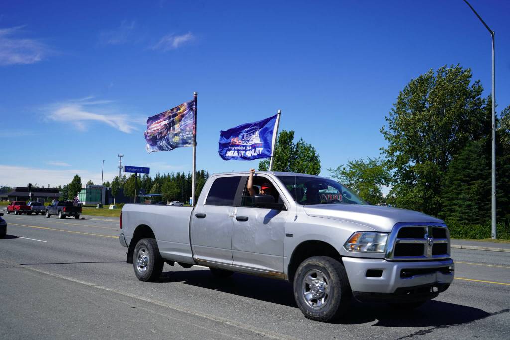 A parade of cars and trucks flying flags in support of former President Donald Trump proceed down the Kenai Spur Highway in Kenai, Alaska, on Sunday, July 14, 2024. (Jake Dye/Peninsula Clarion)