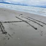 A message scratched in the sand by a beachgoer reads Hi! at Bishops Beach on Tuesday, July 16, 2024, in Homer, Alaska. (Delcenia Cosman/Homer News)