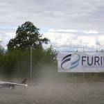 A drone lands while kicking up dust, returning from the test flight for the use of beyond visual line of sight drone aircraft, at Furie Operating Alaskas central processing facility in Nikiski, Alaska, on Wednesday, July 10, 2024. (Jake Dye/Peninsula Clarion)