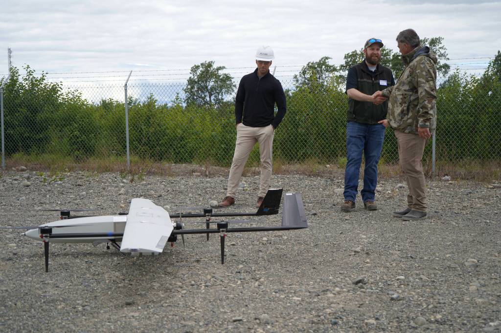 Furie Operations Superintendent Ben Christianson, Furie Operations Engineer Hunter Van Wyhe and HEX President and CEO John Hendrix celebrate a successful test of a drone that flies beyond visual line of sight at Furies central processing facility in Nikiski, Alaska, on Wednesday, July 10, 2024. (Jake Dye/Peninsula Clarion)