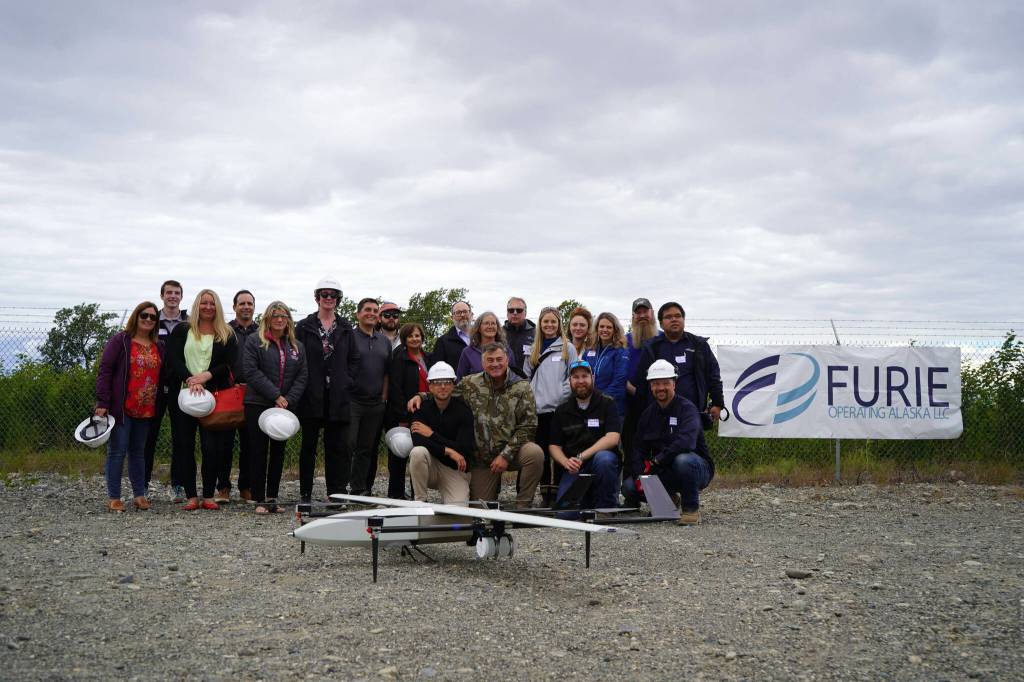 Attendees celebrate a successful test of a drone that flies beyond visual line of sight at Furies central processing facility in Nikiski, Alaska, on Wednesday, July 10, 2024. (Jake Dye/Peninsula Clarion)