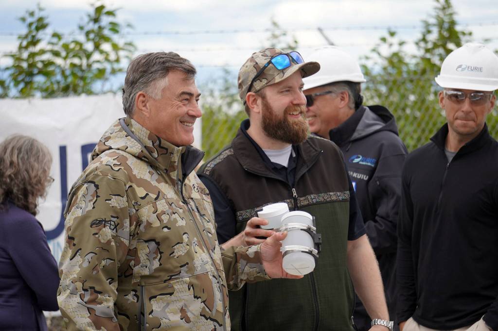 HEX President and CEO John Hendrix and Furie Operations Engineer Hunter Van Wyhe celebrate a successful test of a drone that flies beyond visual line of sight with its returned cargo, a pair of sample water bottles, at Furies central processing facility in Nikiski, Alaska, on Wednesday, July 10, 2024. (Jake Dye/Peninsula Clarion)