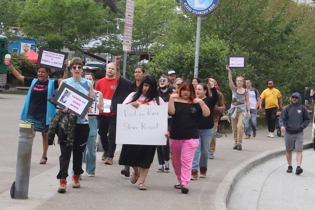 Mark Sabbatini / Juneau Empire
Members of a protest that started at the Alaska State Capitol approach another group at the downtown Juneau Public Library also protesting the death of Steven Kissack last Monday.