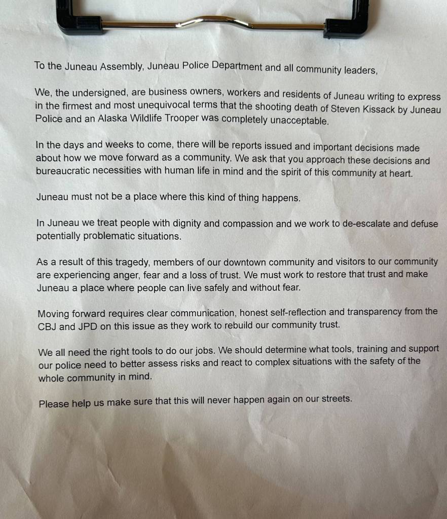 A letter addressed to the City and Borough of Juneau and the Juneau Police Department received signatures during a protest on Sunday in downtown Juneau. (Jasz Garrett / Juneau Empire)