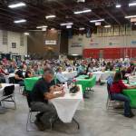 Tables are filled by Junior Market Livestock Auction bidders during the Kenai Peninsula District 4-H Agriculture Expo in the Soldotna Regional Sports Complex in Soldotna, Alaska, on Saturday, July 27, 2024. (Jake Dye/Peninsula Clarion)