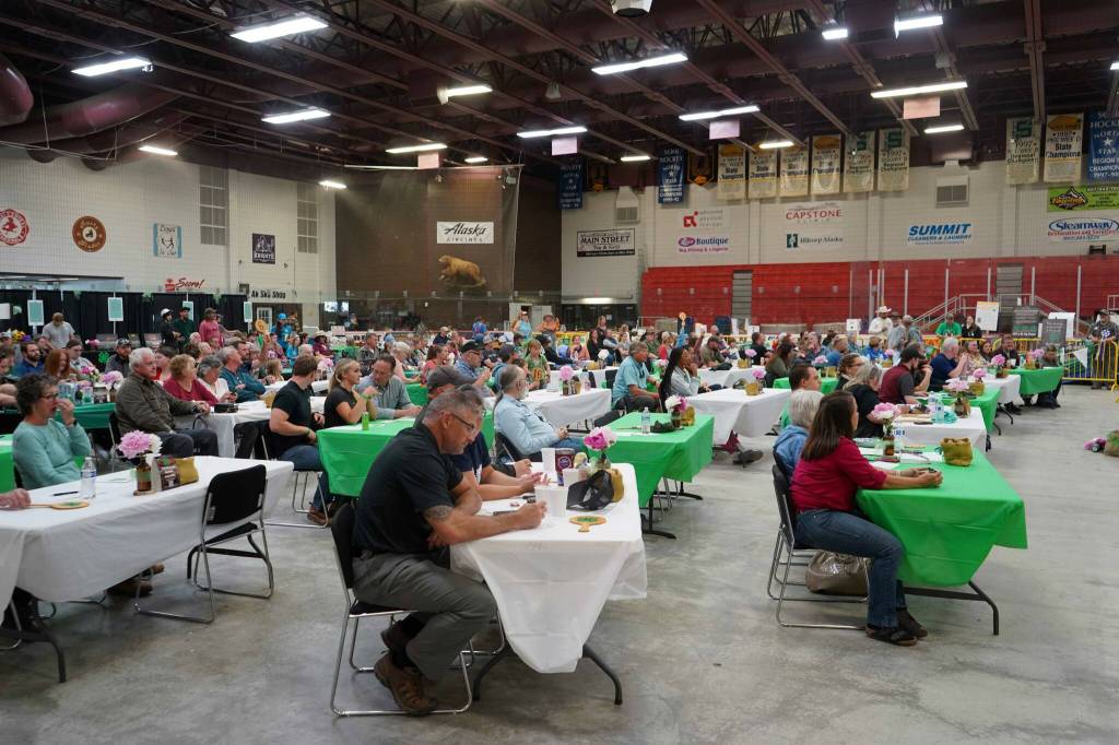 Tables are filled by Junior Market Livestock Auction bidders during the Kenai Peninsula District 4-H Agriculture Expo in the Soldotna Regional Sports Complex in Soldotna, Alaska, on Saturday, July 27, 2024. (Jake Dye/Peninsula Clarion)