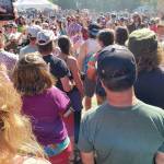 Concertgoers gather around Glitterfox lead singer, Solange Igoa, after she descended the stage into the crowd during the bands Salmonfest performance on Sunday, Aug. 4<ins>,</ins><ins> 2024,</ins> at the Kenai Peninsula Fairgrounds in Ninilchik<ins>,</ins> <ins>Alaska</ins>. (Delcenia Cosman/Homer News)
