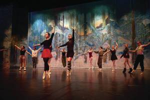 Left to right: Nutcracker ballet performers Aria Palma, Jaelynn Kennon, Tiya Martushev, Talli Dalke, Ireland Styvar, Sofia Loboy and Ella Gustafson rehearse the Snow dance onstage at the Homer High School Mariner Theatre on Sunday, Nov. 19, 2023, in Homer, Alaska. (Photo by Chris Kincaid/courtesy)
