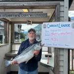 Jerry Martens holds up a 14.33 pound silver salmon on Monday, Aug. 12, 2024, in Seward, Alaska. On Monday, that silver was the largest fish caught in the 69th Annual Seward Silver Salmon Derby and also outweighs last years winning catch. (Photo provided by Seward Chamber of Commerce)